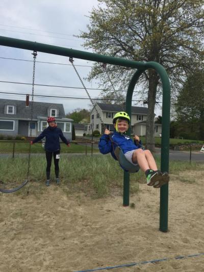Hilary and Oliver Vineyard kill some time before the race by playing on the swings at Mattapoisett Town Beach. Oliver planned to eat lots of chocolate ice cream (his favorite) on the 11-mile ride. Photo by: Grace Ballenger