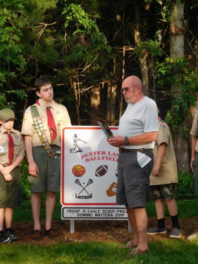 Mattera watches as Park Commissioner David Hughes reads from a plaque for the Eagle Scout Candidate. Photo by: Grace Ballenger