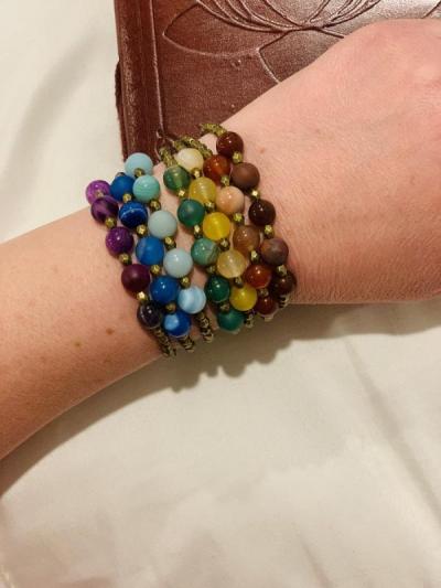A chakra-based collection of Mala bracelets in a rainbow of colors. They can be used individually or together. Photo by: Teah Keogh.