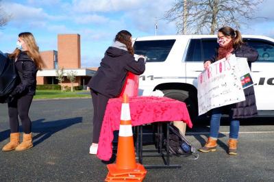 After the toys are all hauled into the building, the club cleans up the donation table. Photo by: Aidan Pollard