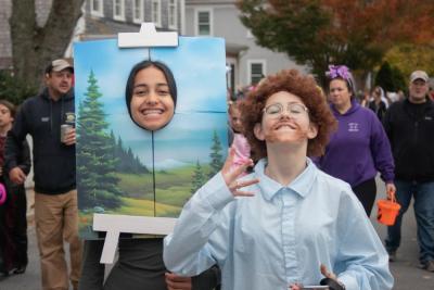 Addy Roy, 13, dressed up as the happy little tree to 11-year-old Claire Barrett’s Bob Ross at the Marion Halloween parade. Photo by: Sawyer Smook-Pollitt