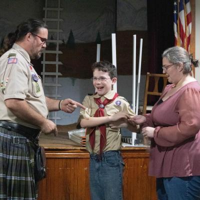 Zack Gagne, center, is thrilled to receive merit badges and his scout rank from Scoutmaster Kevin Thompson, left, as his mother Michelle Gagne looks on. Photo by: Sawyer Smook-Pollitt
