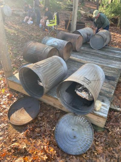 Boy Scouts cooked turkeys inside aluminum trash cans in preparation for a community feast. Photo courtesy: Ed Brown