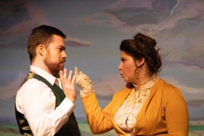 Tristan McCann (Algernon Moncrieff) is given a stern talking-to by Maura Van Voris (Gwendolen Fairfax).