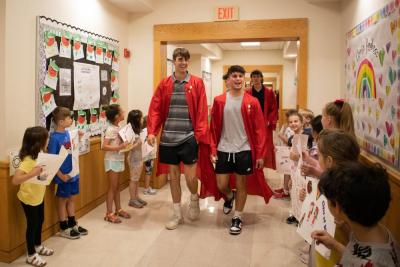 Center School students greet seniors with cheers and applause as they walk the halls of their former elementary school.