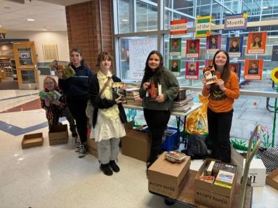 From left: Old Rochester Regional Junior High School students Izzy Hollis, Jessie Detrani, Penny Angeles, Juliana Pinhancos and Seraphina Arruda with books that were collected through the school's book drive. Source: Old Rochester Regional School District and MA Superintendency Union #55
