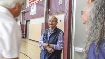 David Ferreira stands in the doorway of the high school gymnasium. The campus building has remained mostly unchanged since it was built in 1975.