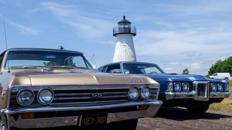 A Chevrolet Chevelle and Pontiac GTO sit parked with Ned’s Point Lighthouse as a backdrop on Sunday, June 28. Photos by: Tim Seeberger