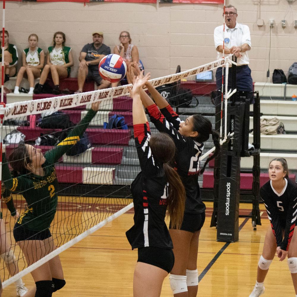 Players defend the net.