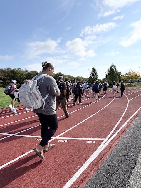 Students and staff at Old Rochester walk with backpacks on at a suicide prevention walk. Students and staff at Old Rochester walk with backpacks on at a suicide prevention walk.