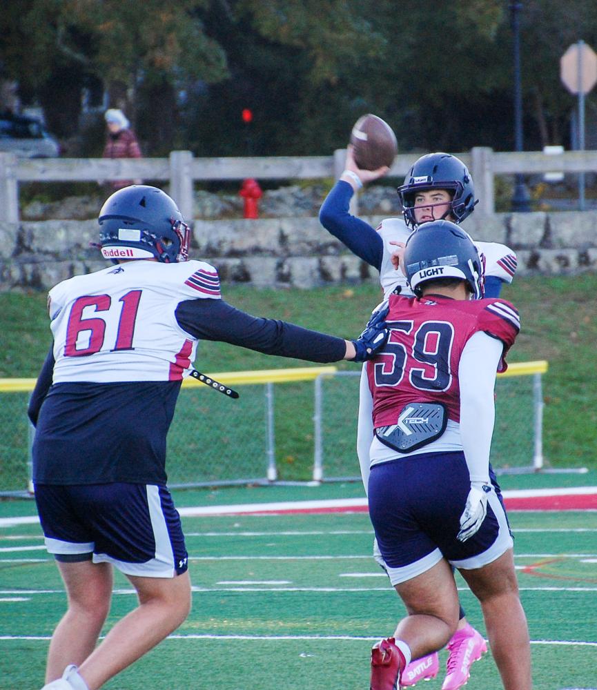 Grady Holmes (white) blocks Marcus Almada (red) before Almada can get to Bourque. Grady Holmes (white) blocks Marcus Almada (red) before Almada can get to Bourque.
