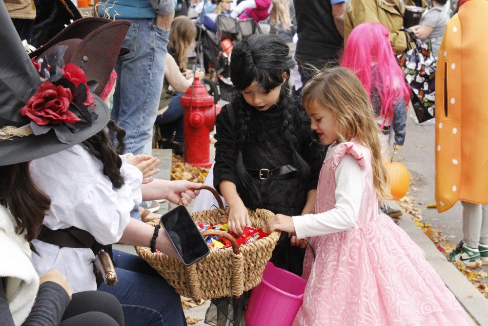 Emmy Philbrook, 5, of Marion stops to grab some candy along the Marion Art Center Halloween Parade route while dressed as a princess. Photos by Grace Ann Natanawan