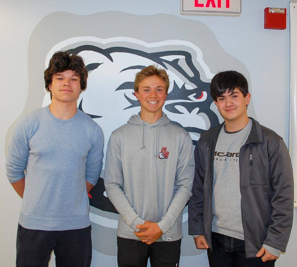James Russell, Luke Pierre and Rafael Duarte, 3 class officers who created the cookbook, pose infront of an Old Rochester Bulldog. Photo by Mari Huglin