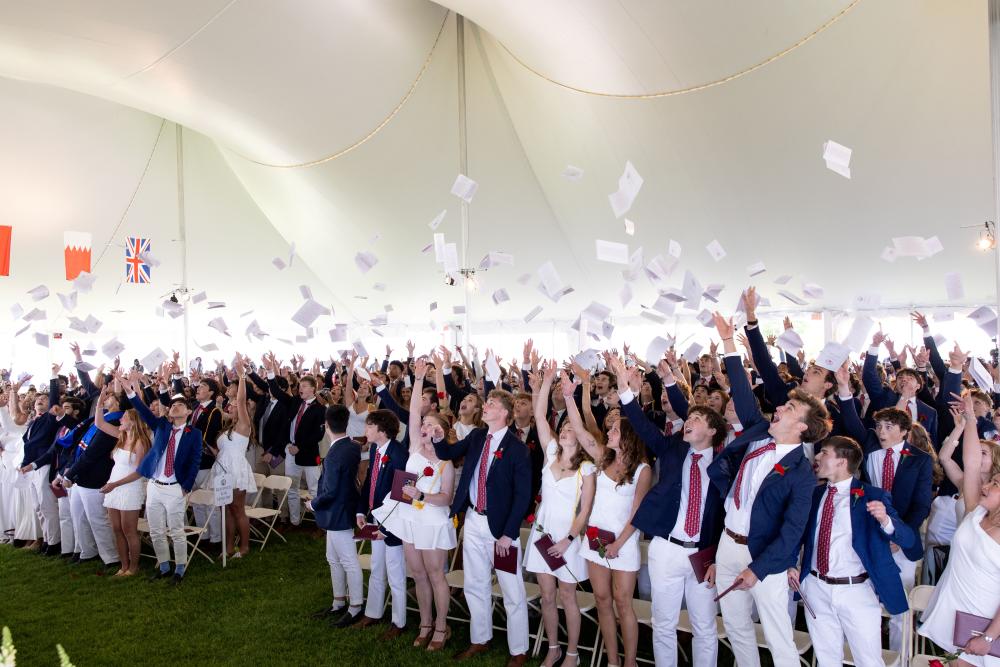 Graduates toss their commencement programs in the air at graduation on Friday, May 22. Photos source: Lawrence Films