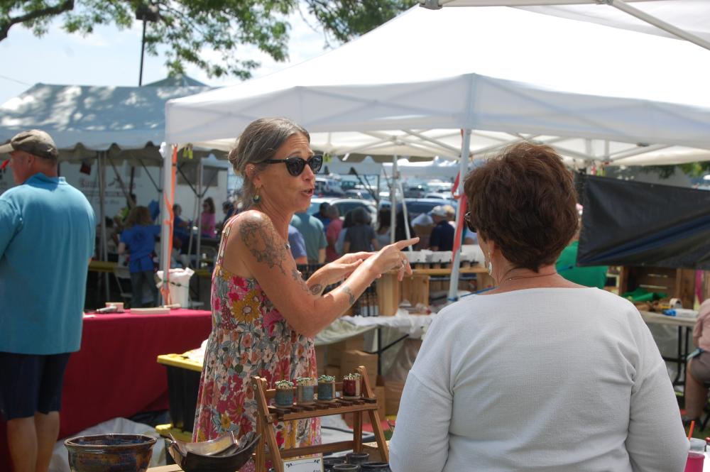 Maureen Starr talks to a customer during Harbor Days at Shipyard Park. Photos by Grace Roche
