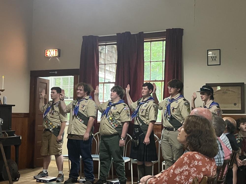 From left: Bryan Correia, Casey Cash, Cole Gretton, Iain McManus, Josh Van Inwegen and Eddie Brown recite the Eagle Charge during the court of honor July 18 at Rochester Grange Hall. Photo by Grace Roche