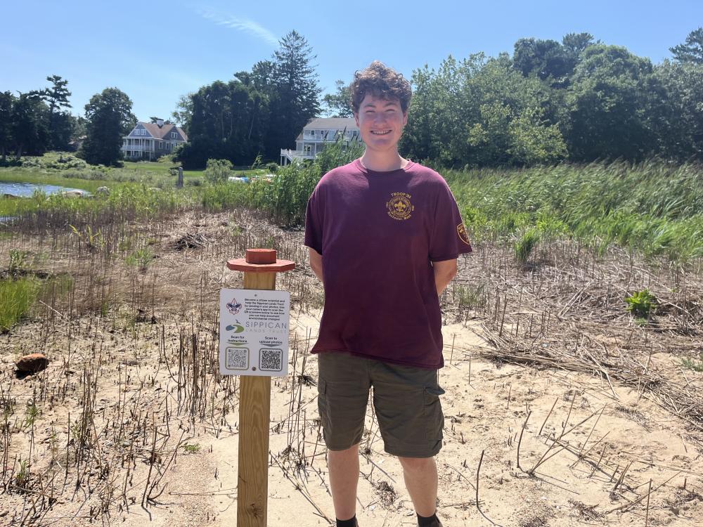 Iain McManus stands next to one of his photo posts at Brainard Marsh. Photos by Grace Roche