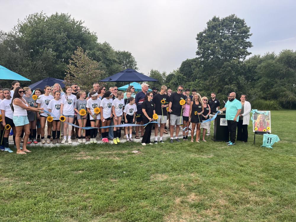 The Eitas family, surrounded by Madelyn's friends and soccer community, cut a ribbon to open Maddie's Circle at the Mariner Youth Soccer Complex on Friday, Aug. 28. Photos by Grace Roche
