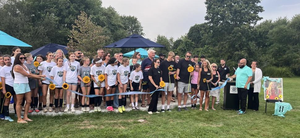 The Eitas family, surrounded by Madelyn's friends and soccer community, cut a ribbon to open Maddie's Circle at the Mariner Youth Soccer Complex on Friday, Aug. 28. Photos by Grace Roche