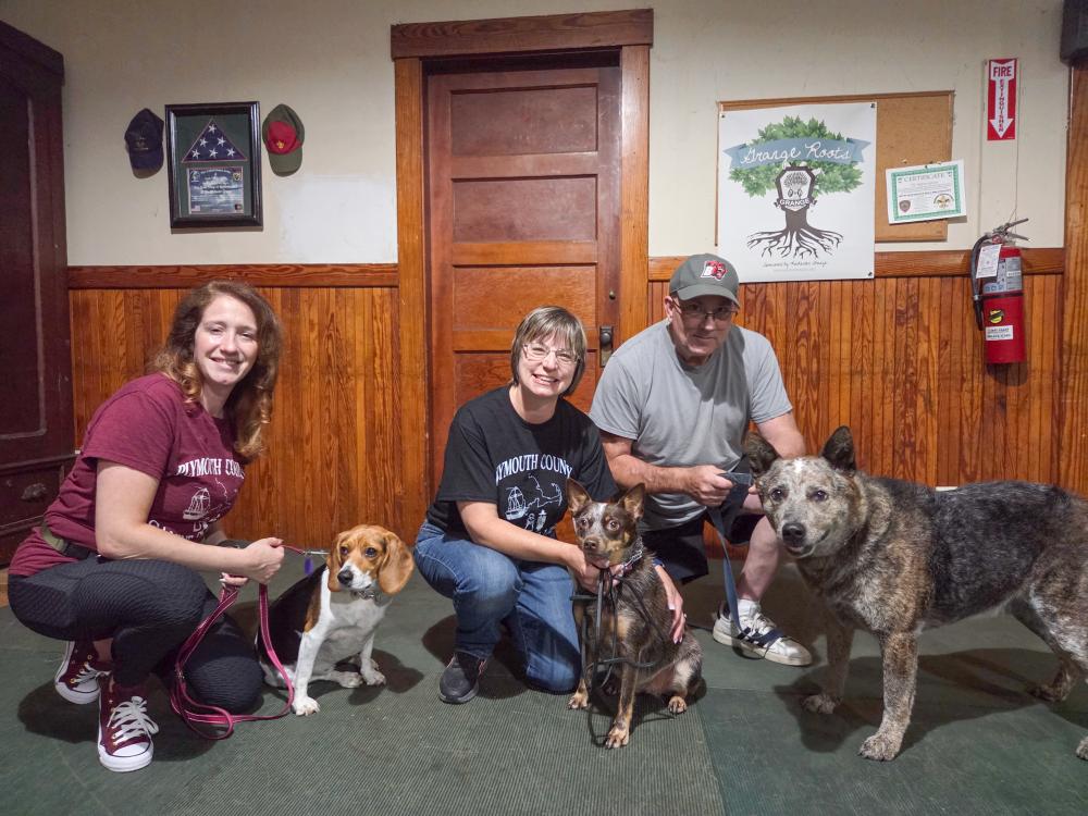 Dog trainers Cristina Fredette and Sherri Swindle, as well as Swindle’s husband, pose with their dogs. Photos by Tanvi Kulkarni