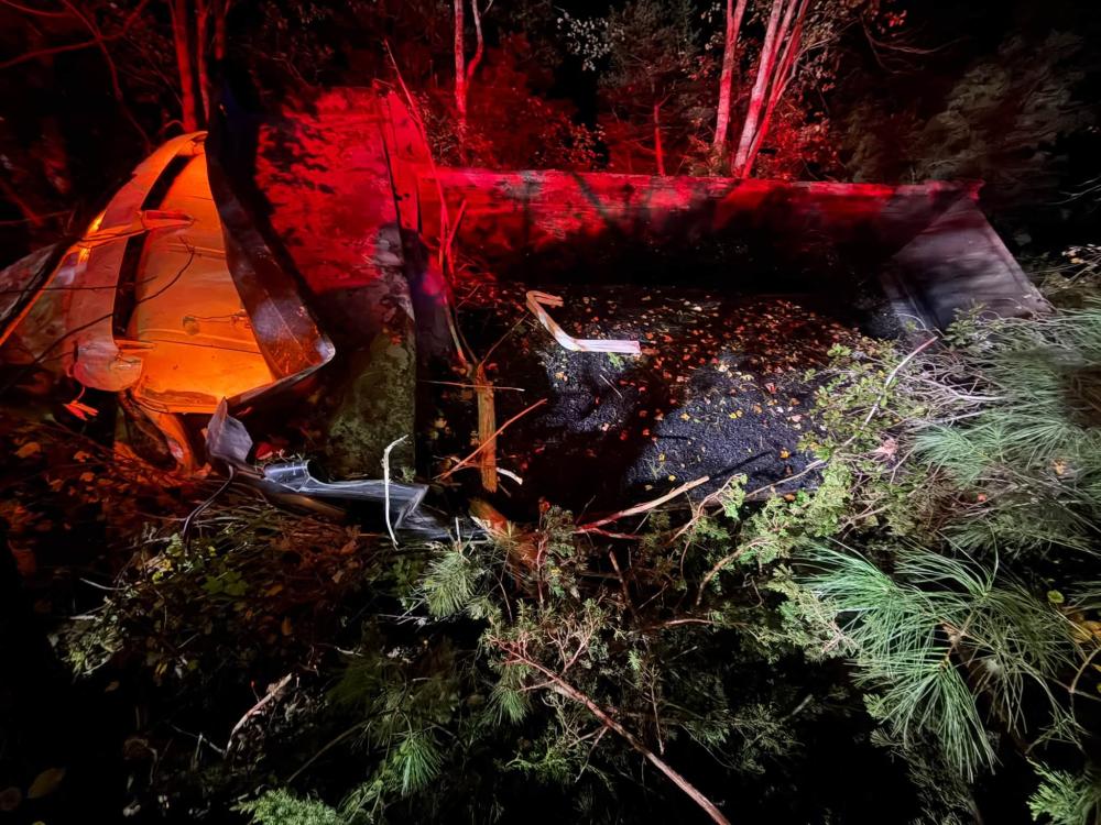 A dump truck crashed into the woods early Thursday morning. Photos source: Mattapoisett Fire Department