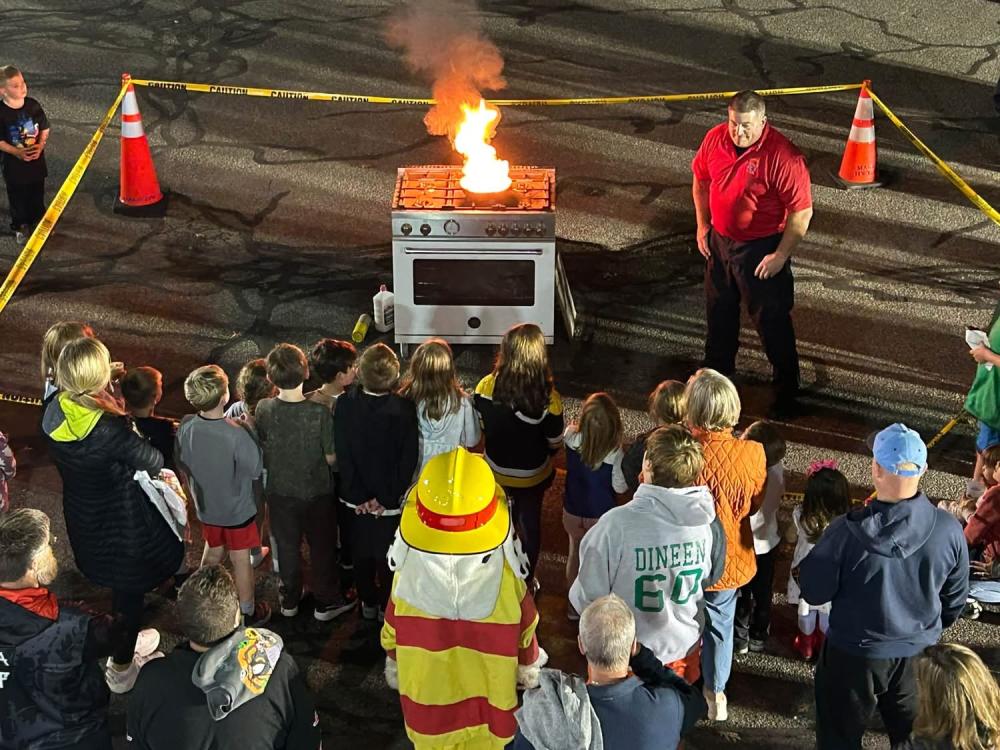 Captain Brooks Wilson demonstrates how to put out a cooking fire at the Oct. 9 open house. Photos source: Marion Fire Department