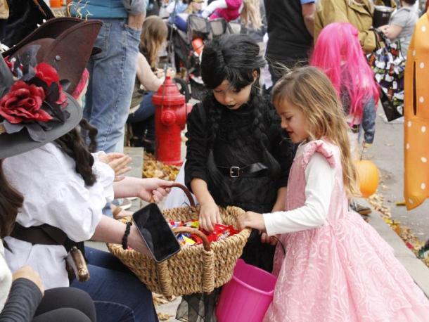 Emmy Philbrook, 5, of Marion stops to grab some candy along the Marion Art Center Halloween Parade route while dressed as a princess. Photos by Grace Ann Natanawan