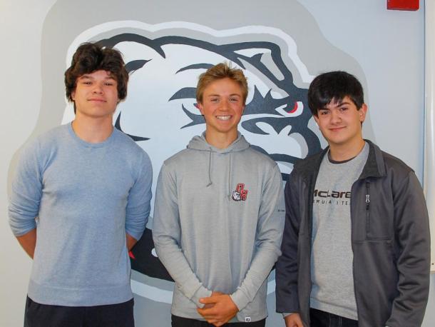 James Russell, Luke Pierre and Rafael Duarte, 3 class officers who created the cookbook, pose infront of an Old Rochester Bulldog. Photo by Mari Huglin