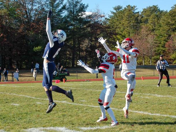 Henry Berry, far right, and Quinn Chisholm (center) jump for the ball. Photos by Mari Huglin