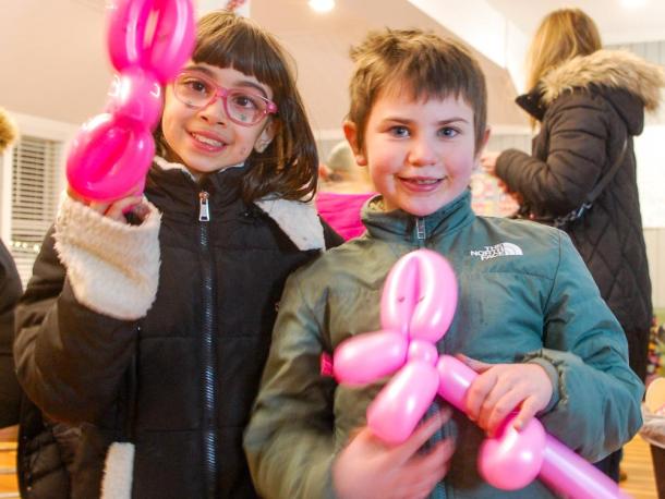 Aria Bell (left) and Margot Ketchel (right) show off their balloon animals at the annual YMCA tree lighting. Photos by Mari Huglin