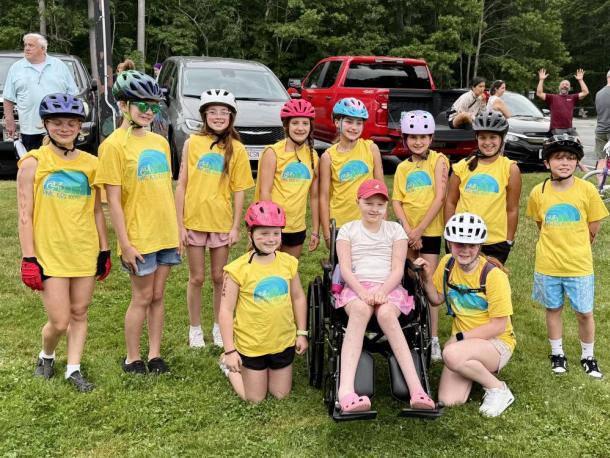 Classmates and friends surround Vivian Jones, center, at the June 2025 Kids Pan-Mass Challenge, a bike-a-thon that raises money for cancer research and treatment. Photos source: Jennifer Jones.