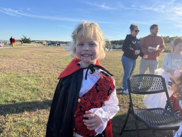 Hunter Hollis, 5, smiles with his freshly-painted vampire teeth to complete his costume at the Oct. 24 trunk or treat. Photos by Grace Roche