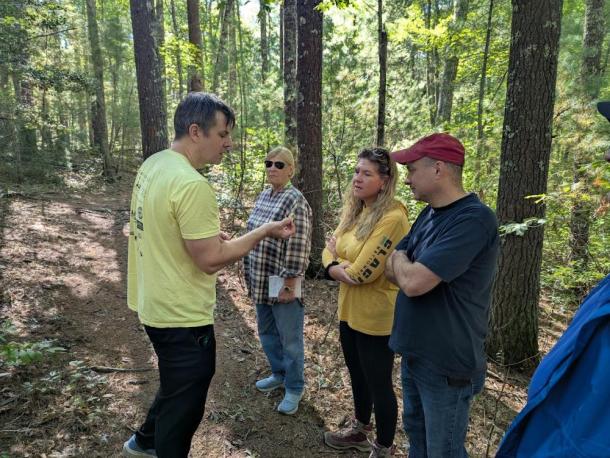 Adam Korejeve shows walk participants a mushroom. Photos source: Eileen Marum