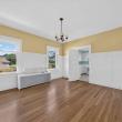 Unit 2 dining room with a chandelier, wainscoting and two windows at 370 Maple Street, New Bedford