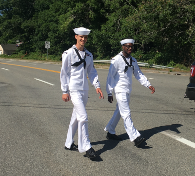 Cameron Mastin, left, and Tylan Allen from Alabama, visiting sailors from the soon to be commissioned submarine Massachusetts, marched as part of their visit to town.