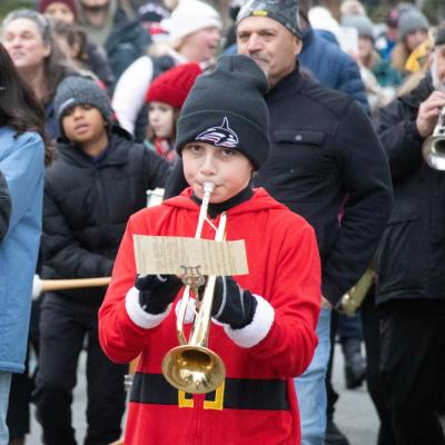 The Sippican School Band marched down the streets of Marion and played Rudolf the Red Nosed Reindeer. Here, Sam Long plays his trumpet in the band.