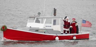 Santa and Mrs. Claus wave to their fans from aboard a boat to kick of the Marion Village Christmas Stroll on Sunday, Dec. 11. Photos by: Sawyer Smook-Pollitt