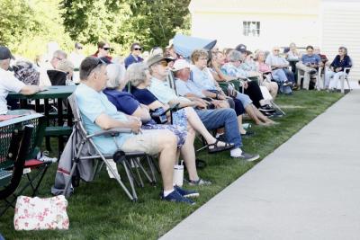 Audience members enjoy the outdoor performance behind the Rochester senior center.