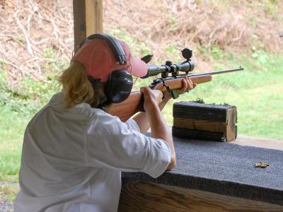 One woman aims her rifle at the 50 yard range. One woman aims her rifle at the 50 yard range.
