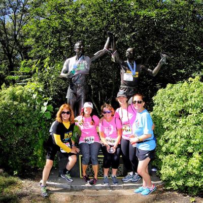 (From left to right) Sue Smith, Kara Pernice, Sue Kindregan, Deborah (Pernice) Duffy and Donna Tocci stop at the Johnny Kelley statute in Newton during their first year walking as a team. 