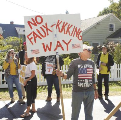 Ben Rogers of Mattapoisett holds up a homemade sign rejecting white supremacy in the United States.