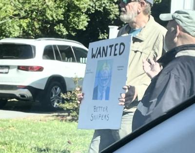 A protestor at the Mattapoisett "No Kings" rally holds a violent sign, leading to a police investigation. Source: Paul Criscuolo