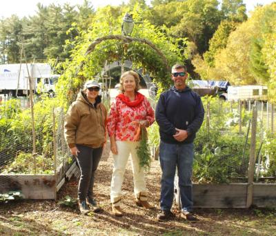 (left to right) Brooke Johnson, Barbie Burr and Mike Healey stand in front of the garden beds.