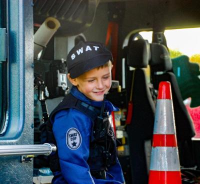 Beckham Sadler, age 5, sits in a fire truck dressed as a S.W.A.T. officer. Beckham Sadler, age 5, sits in a fire truck dressed as a S.W.A.T. officer.