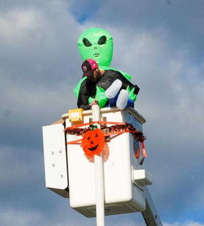 The Department of Public Works sent candy from the top of their truck to trick-or-treaters below. The Department of Public Works sent candy from the top of their truck to trick-or-treaters below.