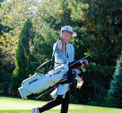 Brady Mills grabs his bag and moves down the course.  Brady Mills grabs his bag and moves down the course.