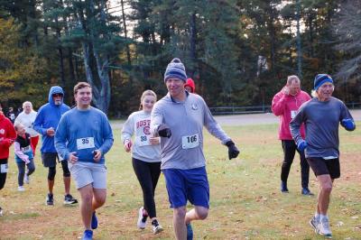 Mark Milhench jokes with the crowd as Teddy Caroll and Ella Batholonew follow behind. 