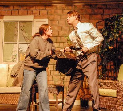 Jade Beauregard (Catherine) and Oliver Asker (Hal) fight over a bag.