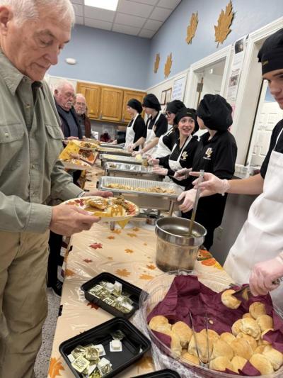 Students serve senior residents at the Rochester Council on Aging.