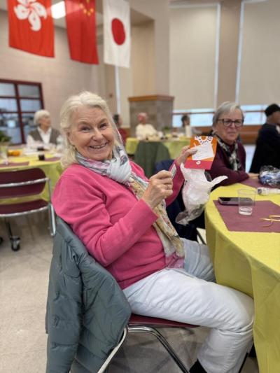 Another winner of a raffle is pleased to share her prize.